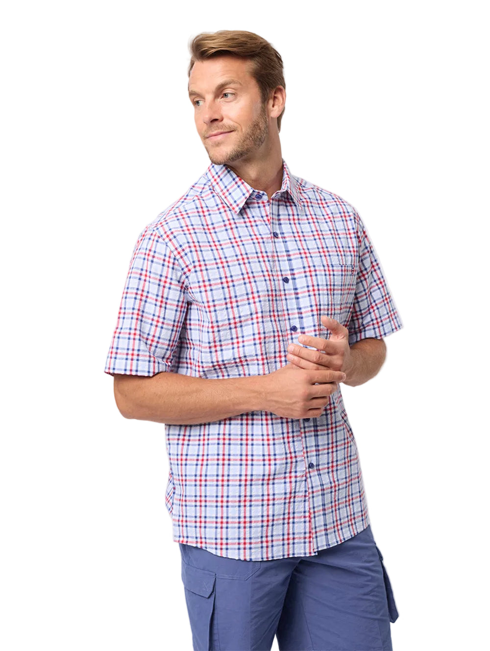 Man wearing a plaid shirt and blue pants on a white background