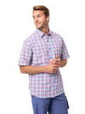 Man wearing a plaid shirt and blue pants on a white background