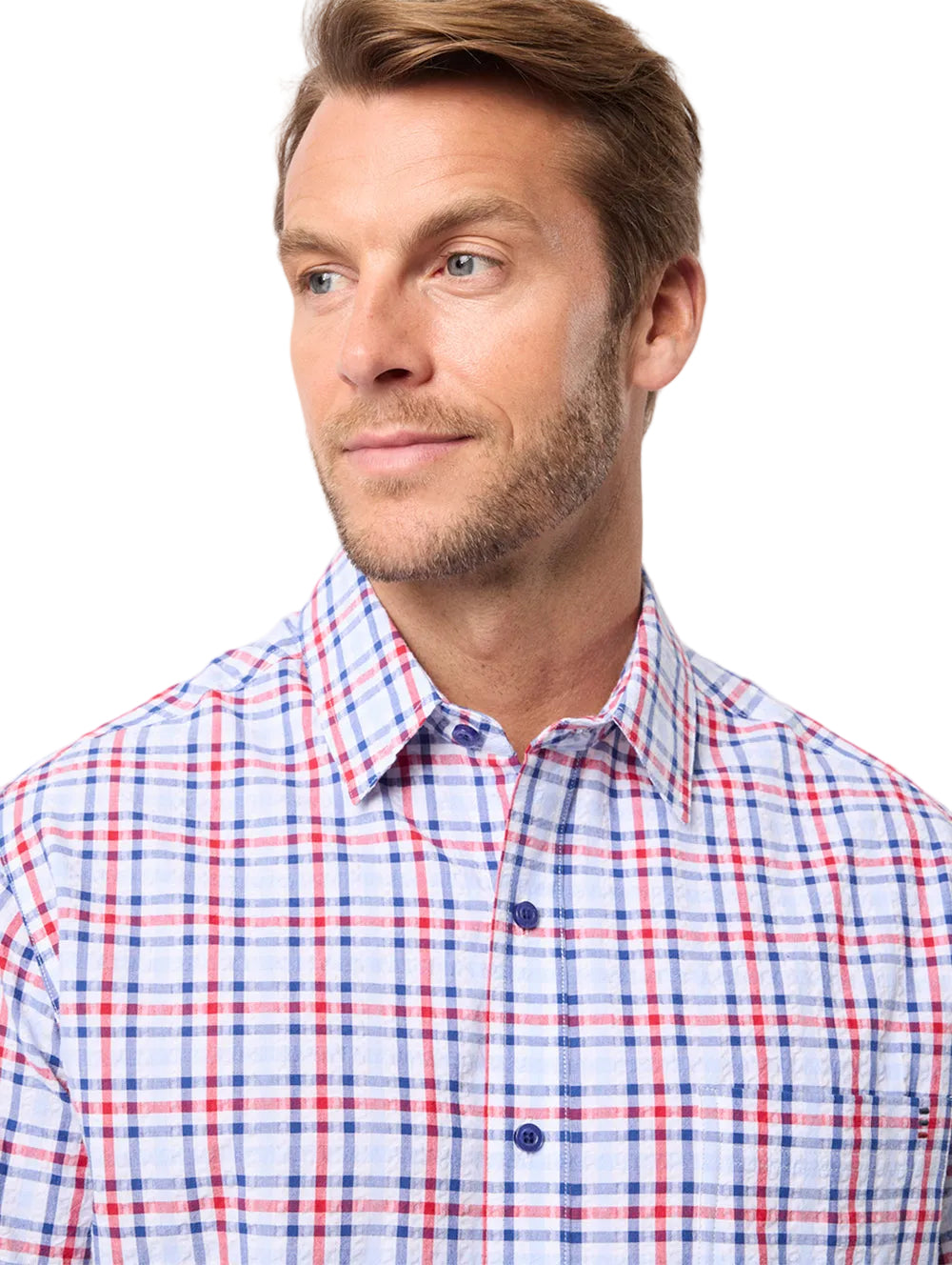 Man wearing a red, white, and blue checkered shirt against a light background
