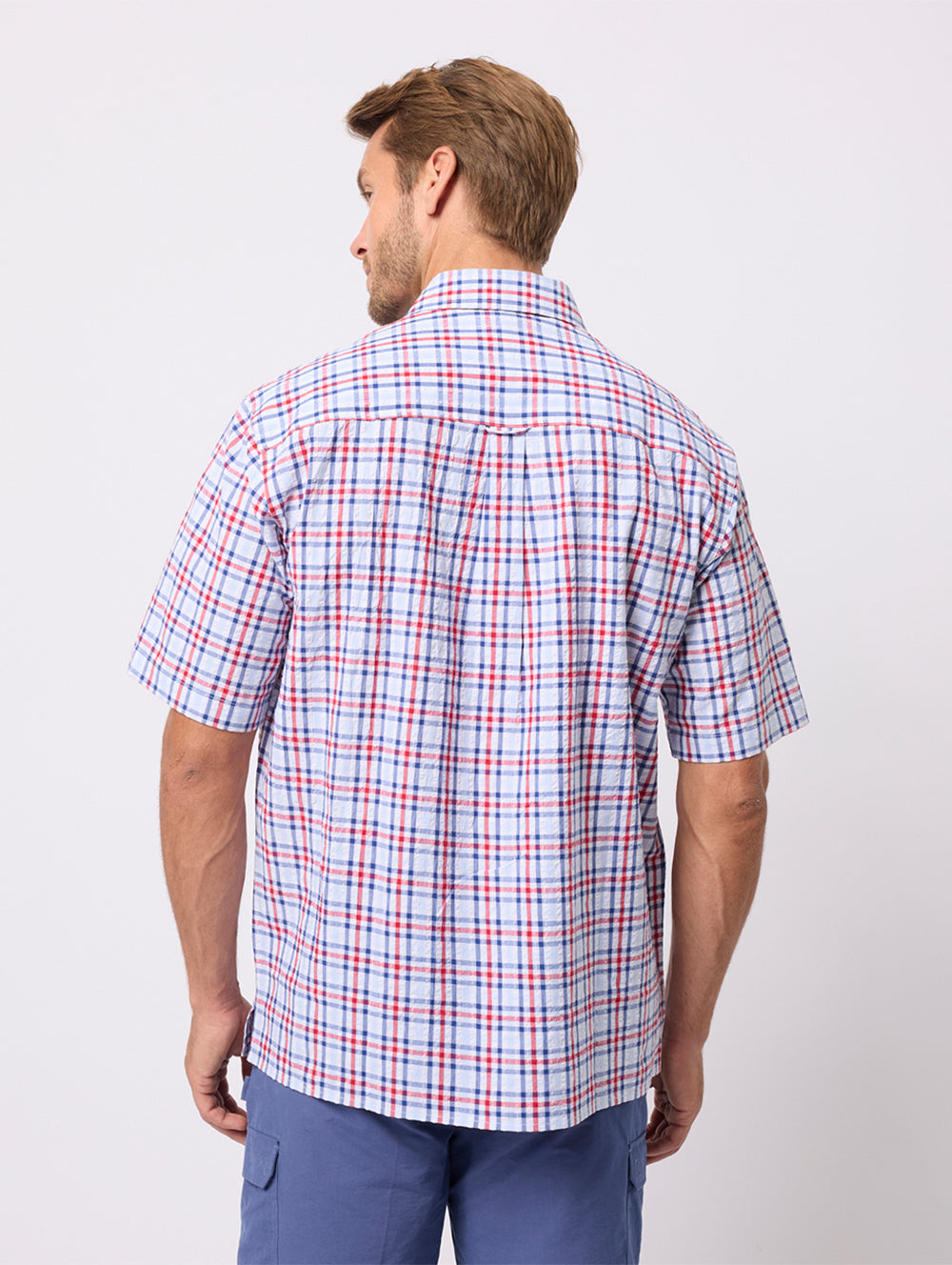 Man wearing a plaid short-sleeve shirt on a white background