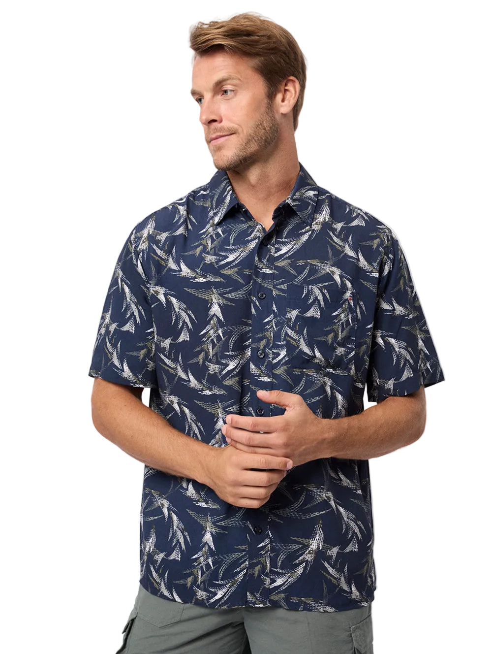 Man wearing a navy patterned shirt on a light gray background