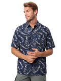 Man wearing a navy patterned shirt on a light gray background
