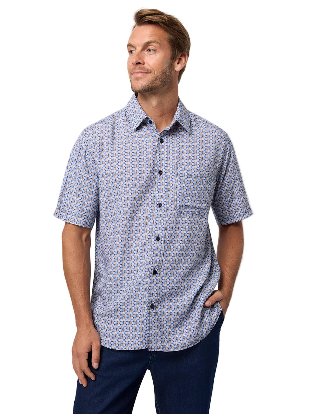 Man wearing a patterned short-sleeve shirt against a plain background