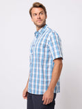 Man wearing a blue plaid shirt against a white background