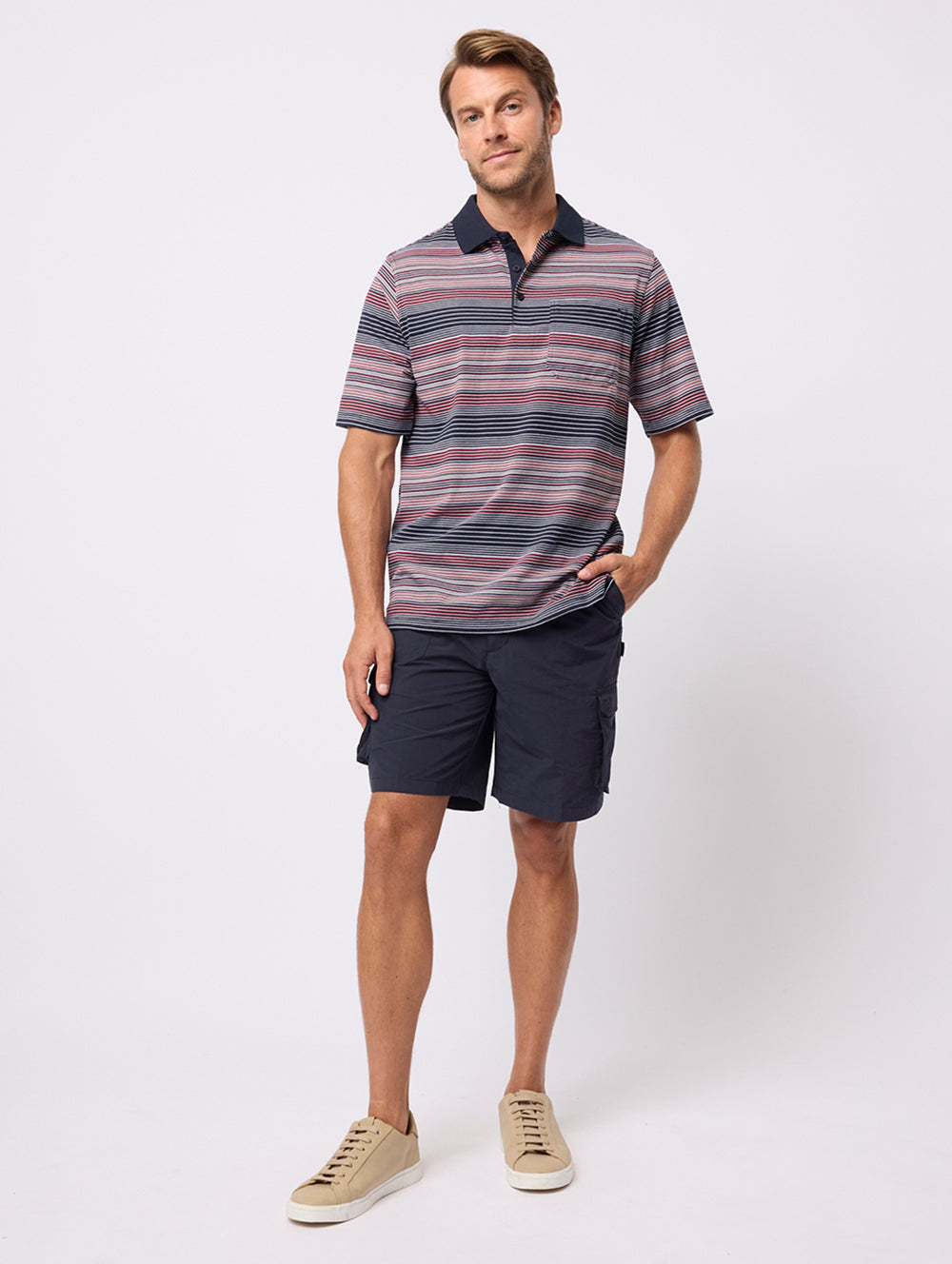 Man wearing a striped polo shirt and shorts on a white background