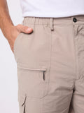 Beige cargo pants with a white background