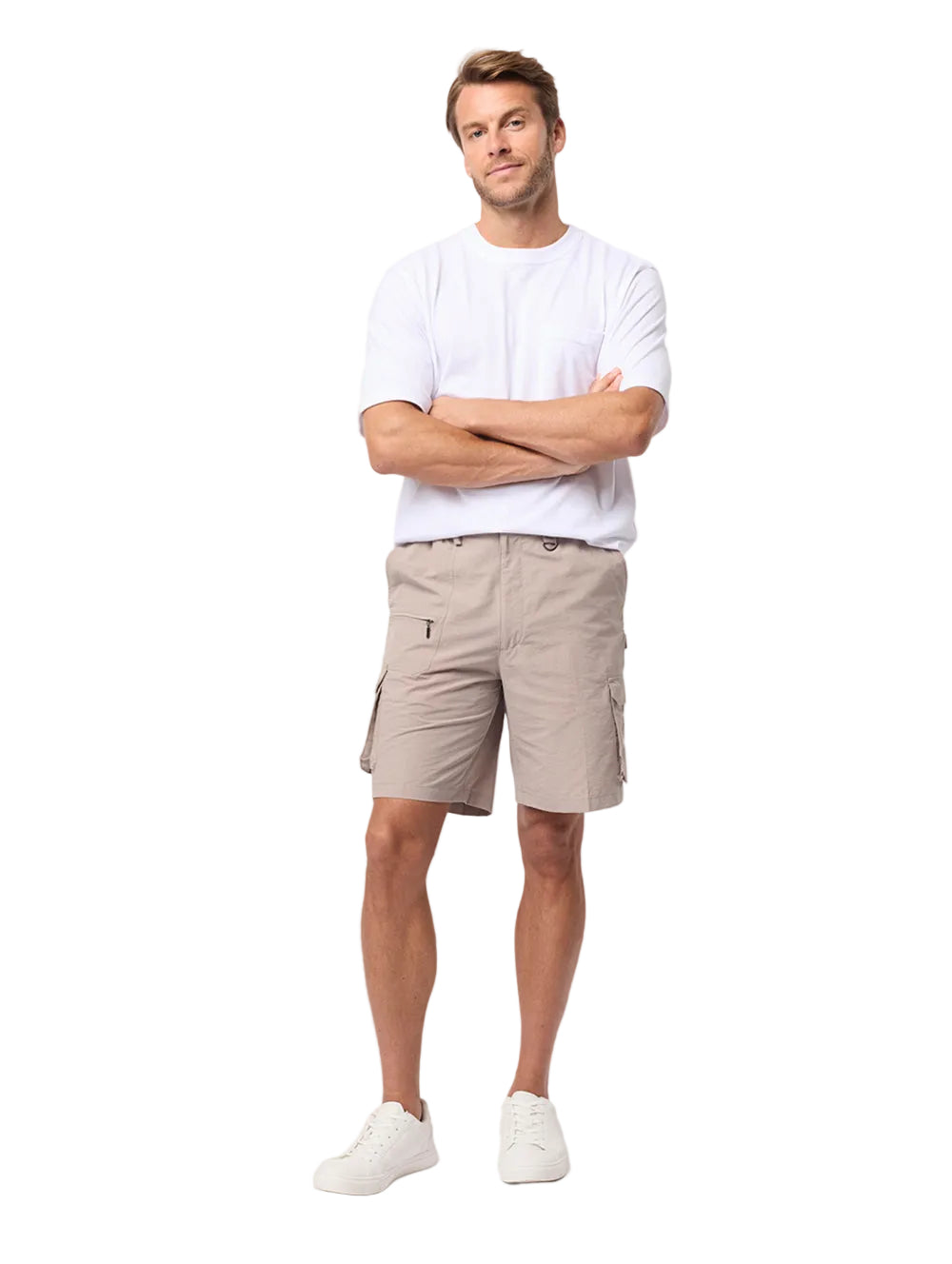 Man wearing a white shirt and beige shorts standing against a white background