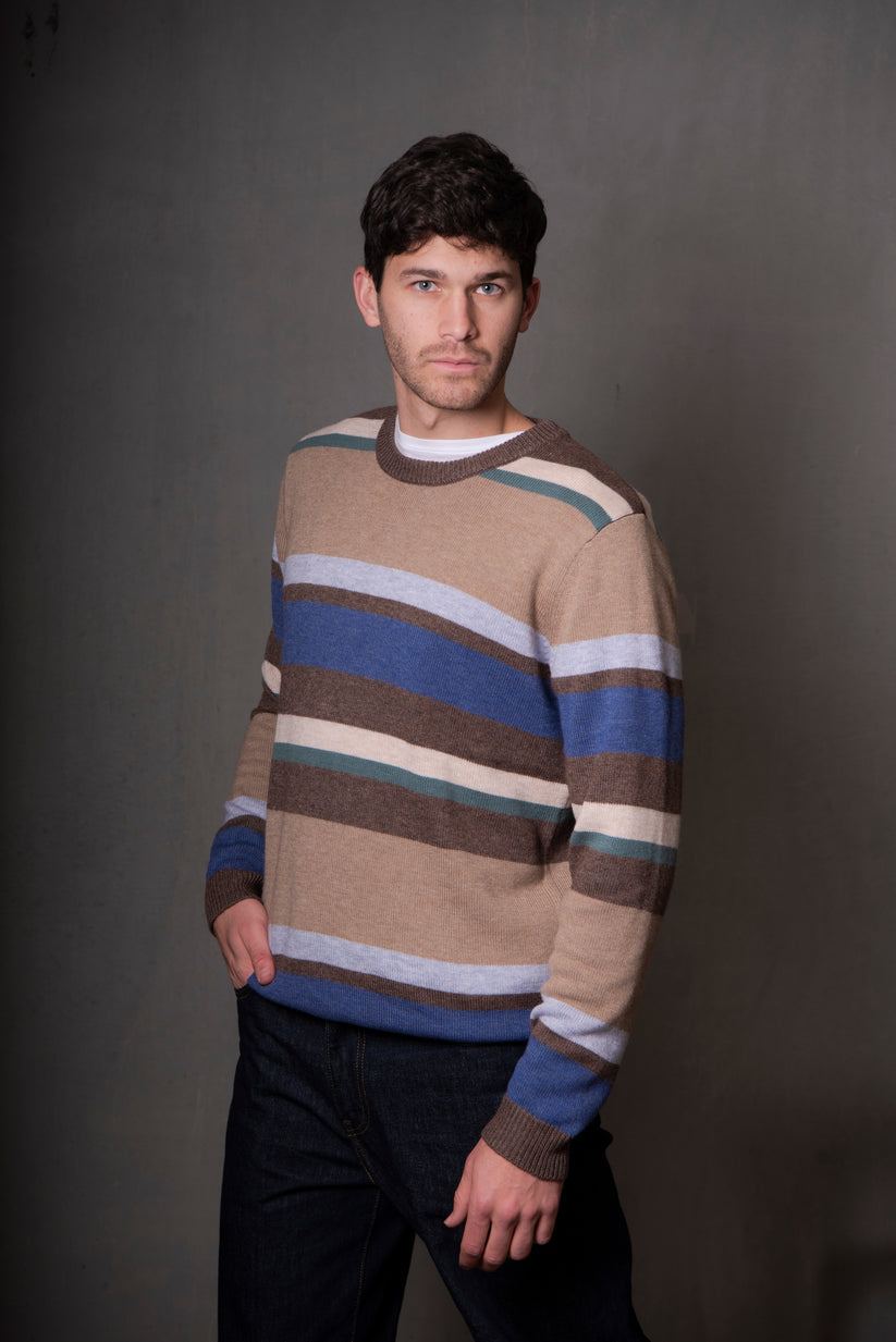 Man wearing a striped sweater against a plain background