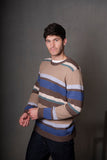 Man wearing a striped sweater against a gray background