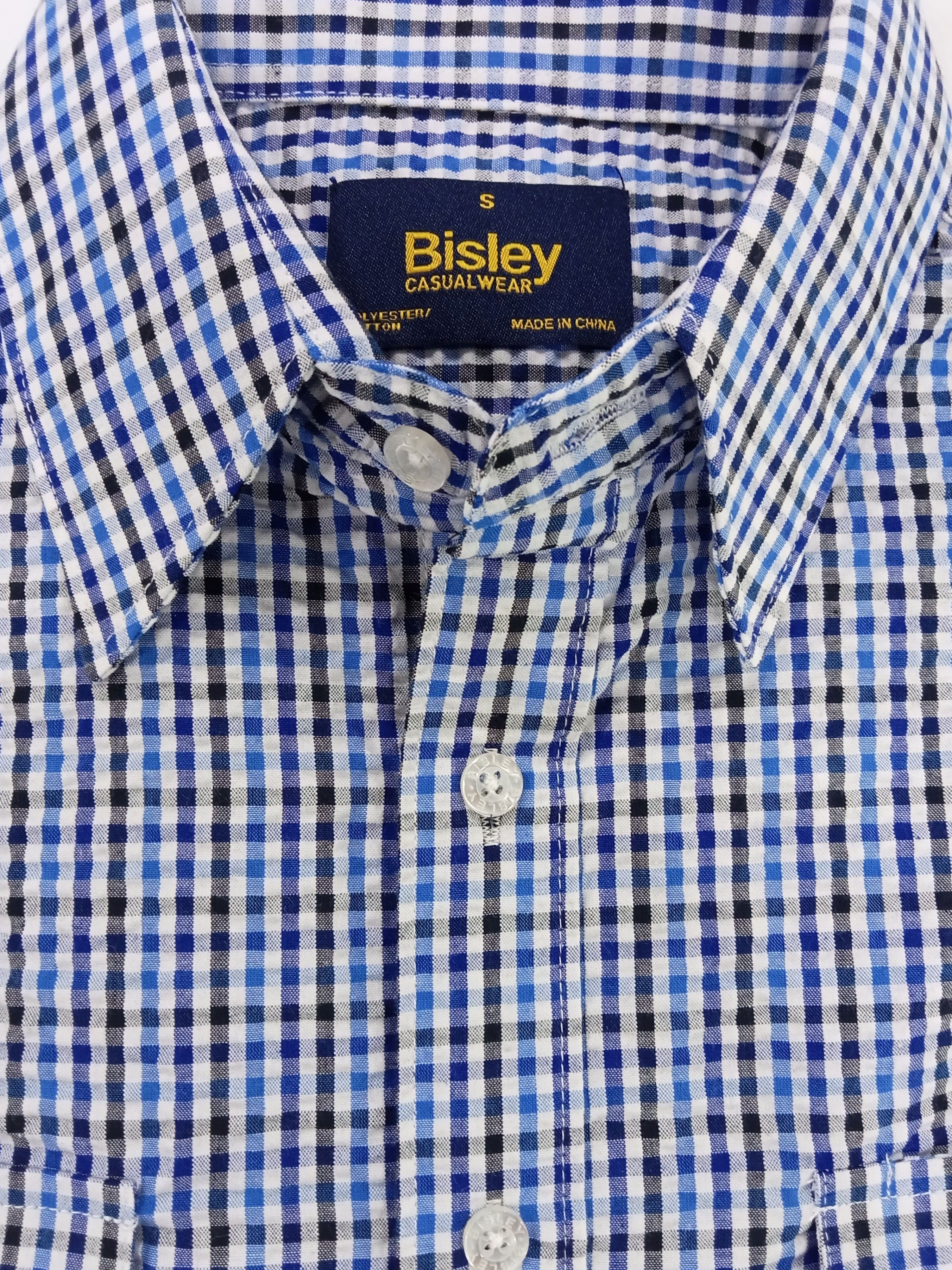 Close-up of a blue and white checkered shirt with Bisley branding on the collar.