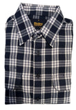 Folded navy and white checkered shirt on a white surface