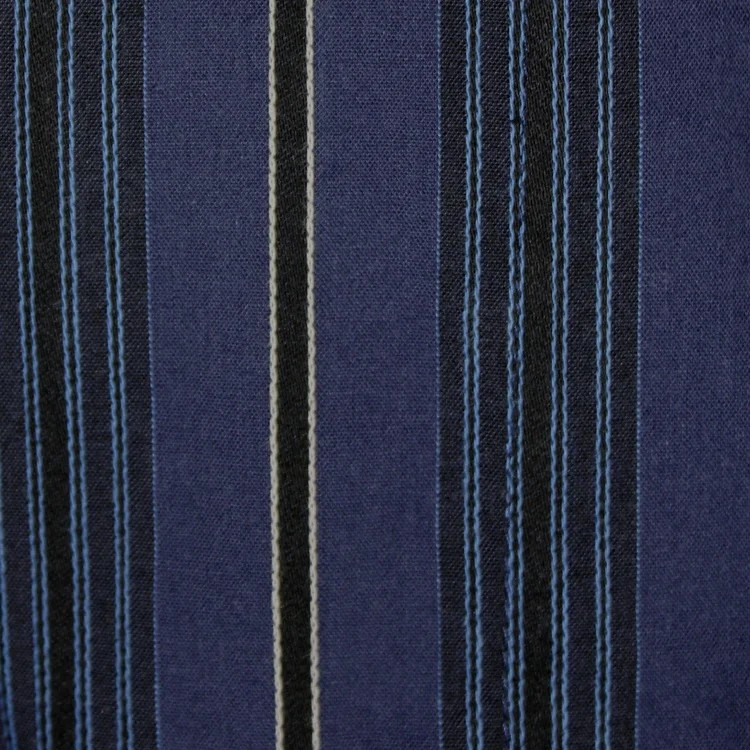 Close-up of blue fabric with thin black and white stripes