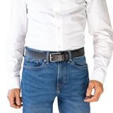 Person wearing a white shirt and blue jeans with a black belt on a white background