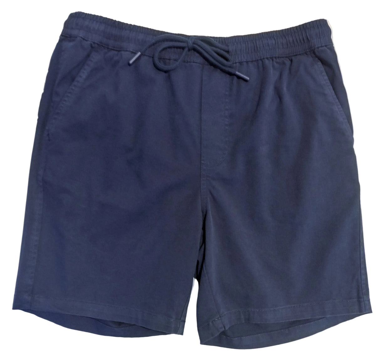 A pair of dark navy blue drawstring shorts laid flat on a white surface, with a person's legs visible at the bottom edge.