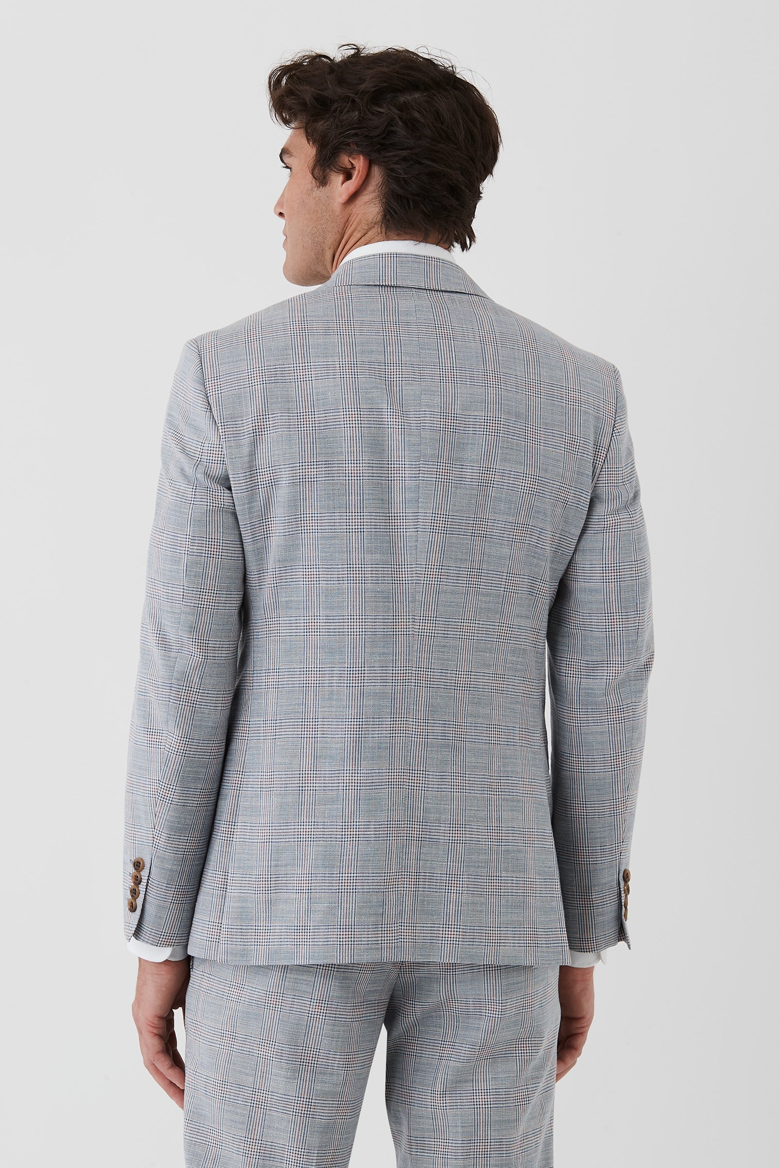 Man wearing a gray checkered suit on a white background