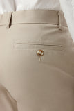 Close-up of beige pants with a button and zipper detail.