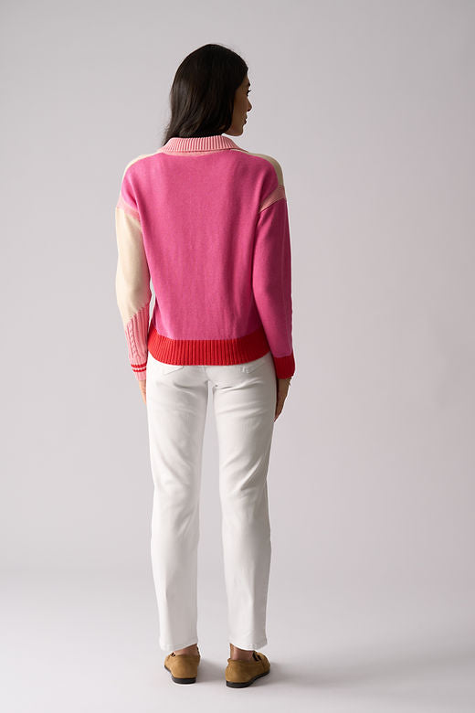 Person wearing a pink sweater with a white background