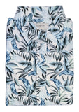 A folded short-sleeve button-up shirt with a blue, gray, and black tropical palm leaf pattern on a white background, displayed on a white surface.