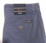 Close-up of the back waistband and pocket area of Le Short Stretch Comfort Trousers in a textured navy blue fabric, showing the brand labels and a brown button.