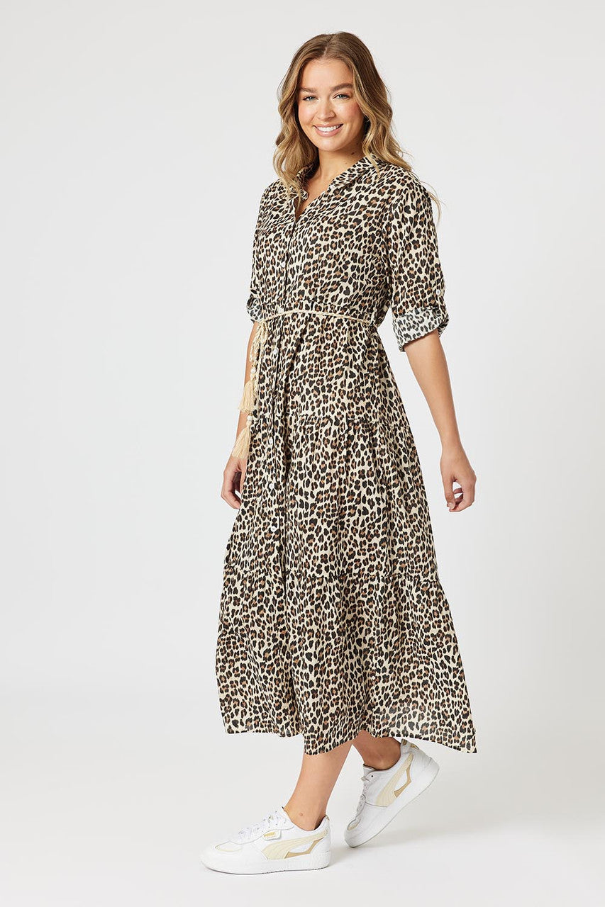 Woman wearing a leopard print dress on a white background