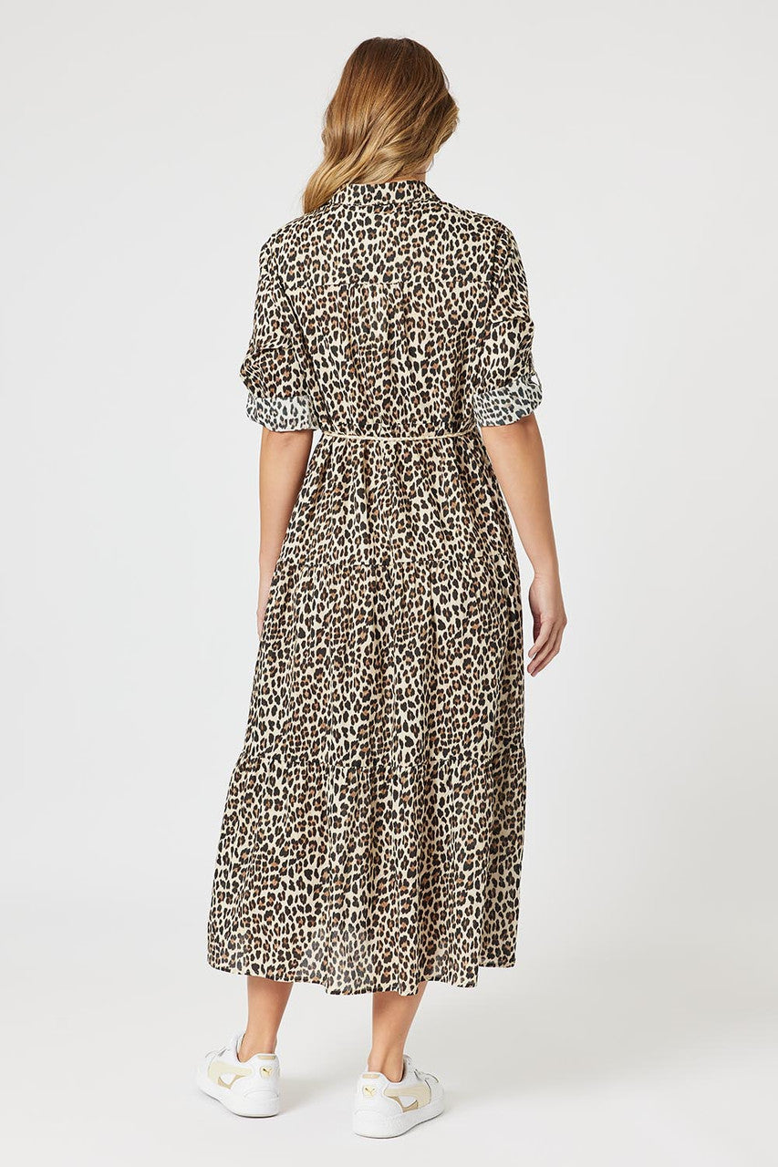 Woman wearing a leopard print dress on a white background