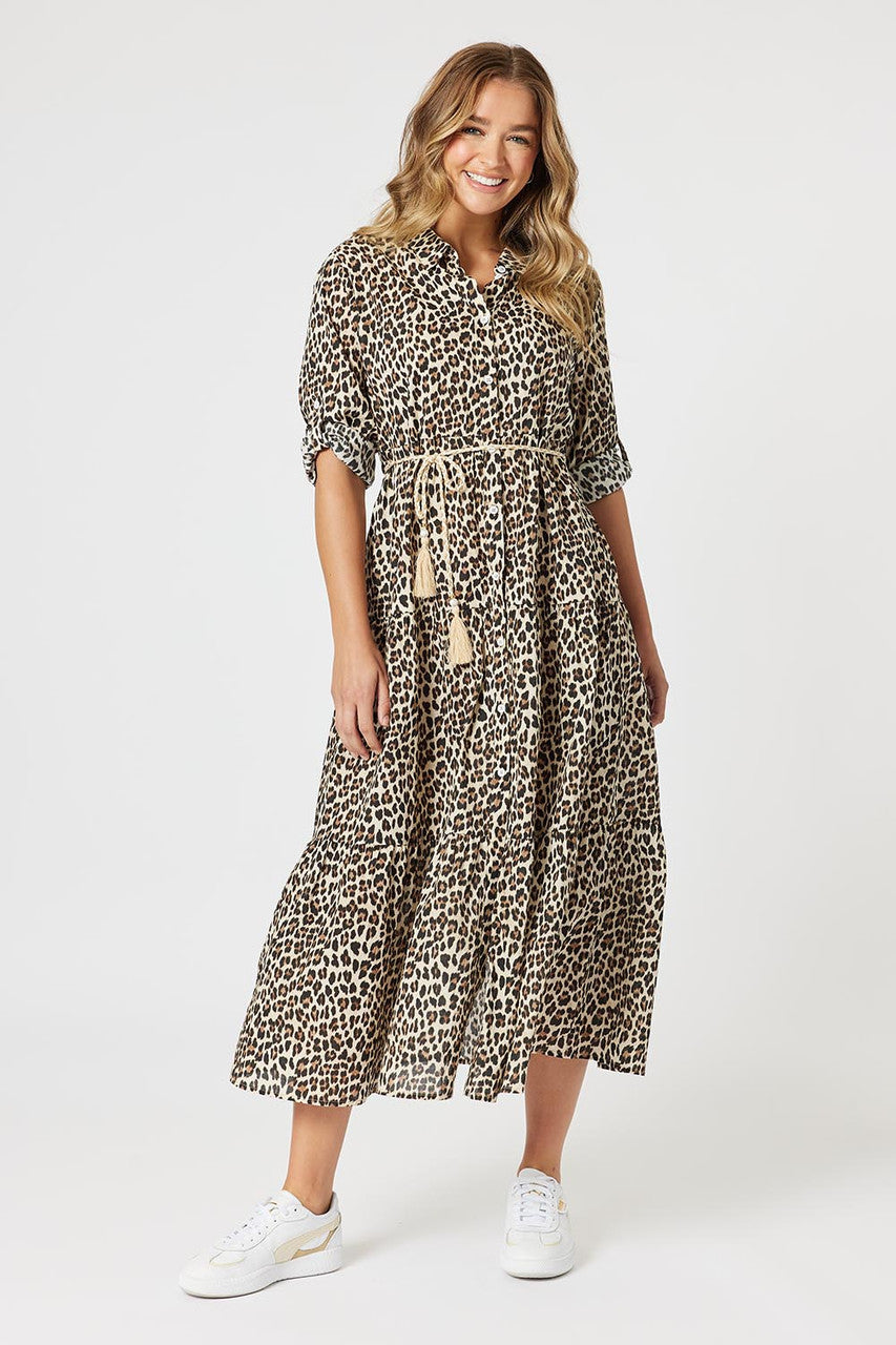 Woman wearing a leopard print dress on a white background