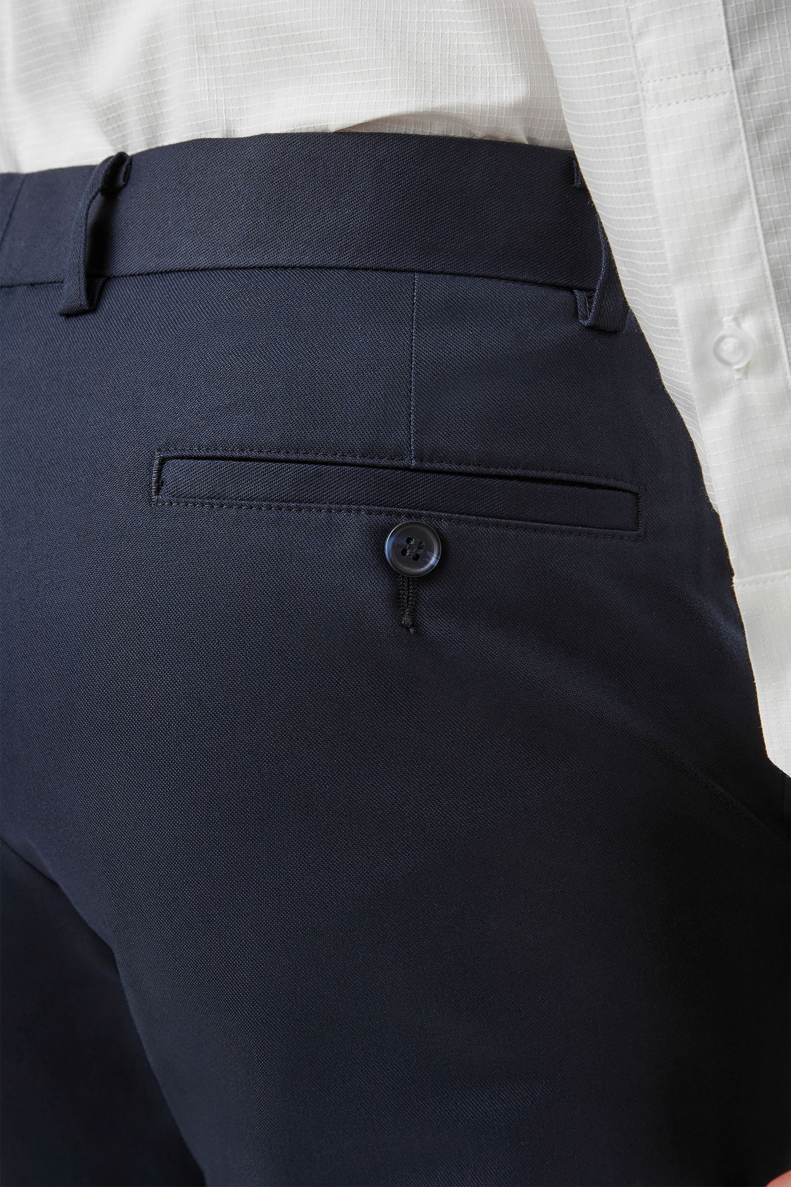 Navy blue pants with a button on a white background