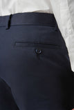 Navy blue pants with a button on a white background
