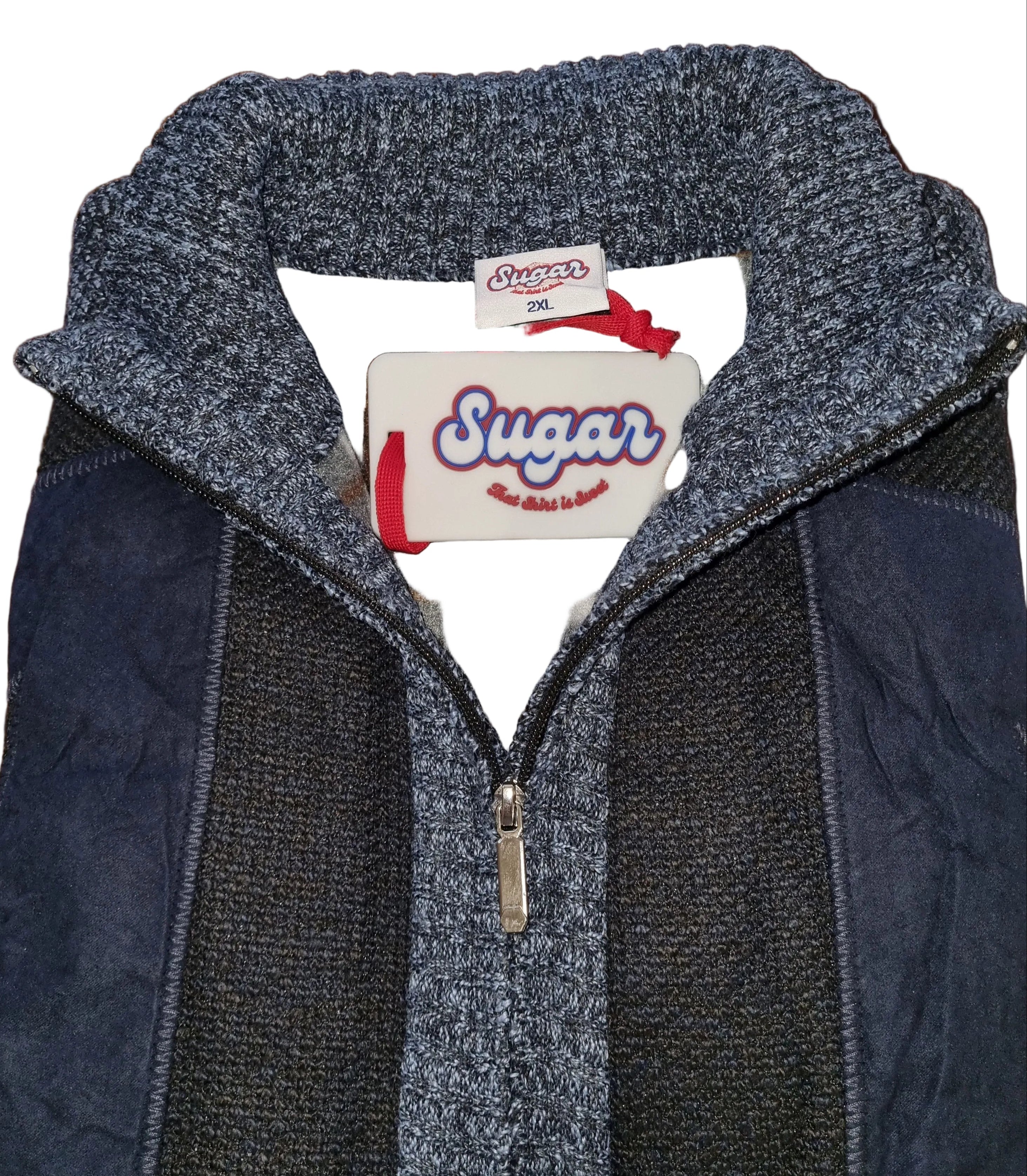 Close-up of a blue jacket with a visible brand tag on a wooden surface