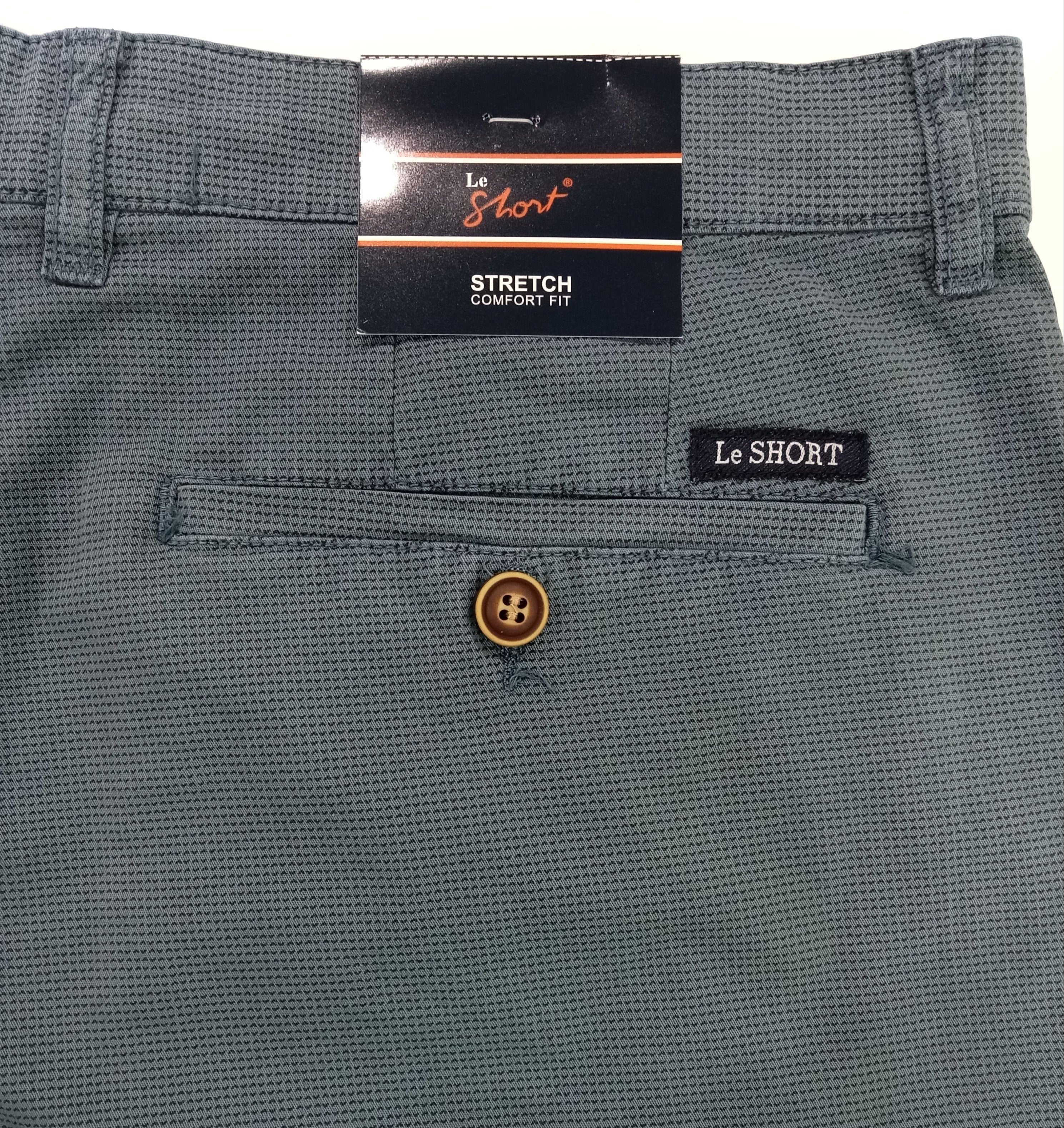 Close-up of gray shorts with a brand label on a white background