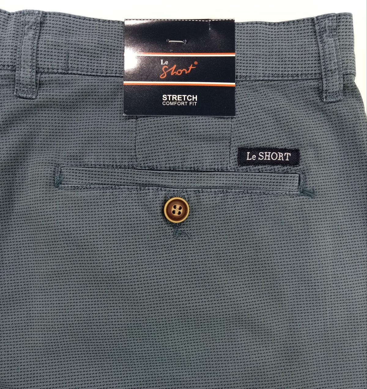 Close-up of gray shorts with a brand label on a white background