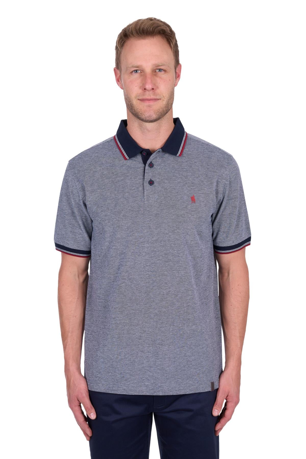 Man wearing a gray polo shirt with navy trim on a white background