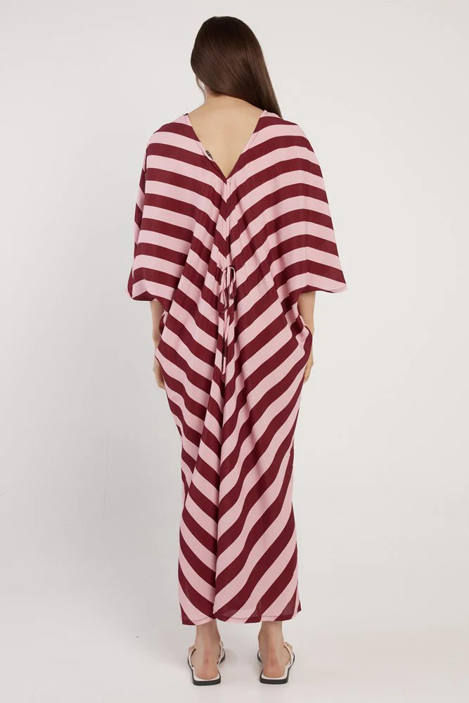 Woman wearing a red and white striped dress on a white background