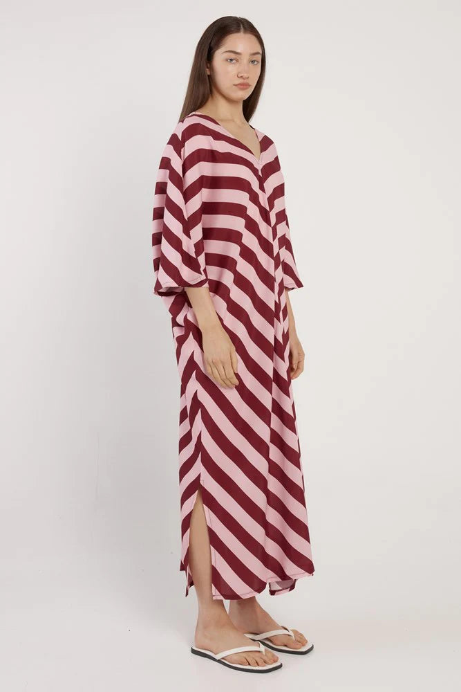 Woman wearing a red and white striped dress on a white background