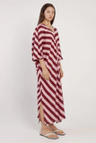 Woman wearing a red and white striped dress on a white background
