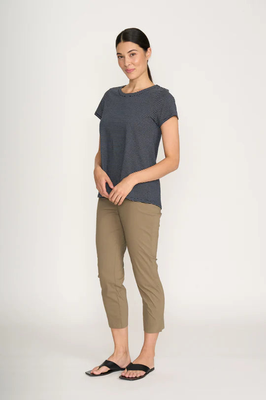 Woman wearing a striped t-shirt and beige pants on a white background