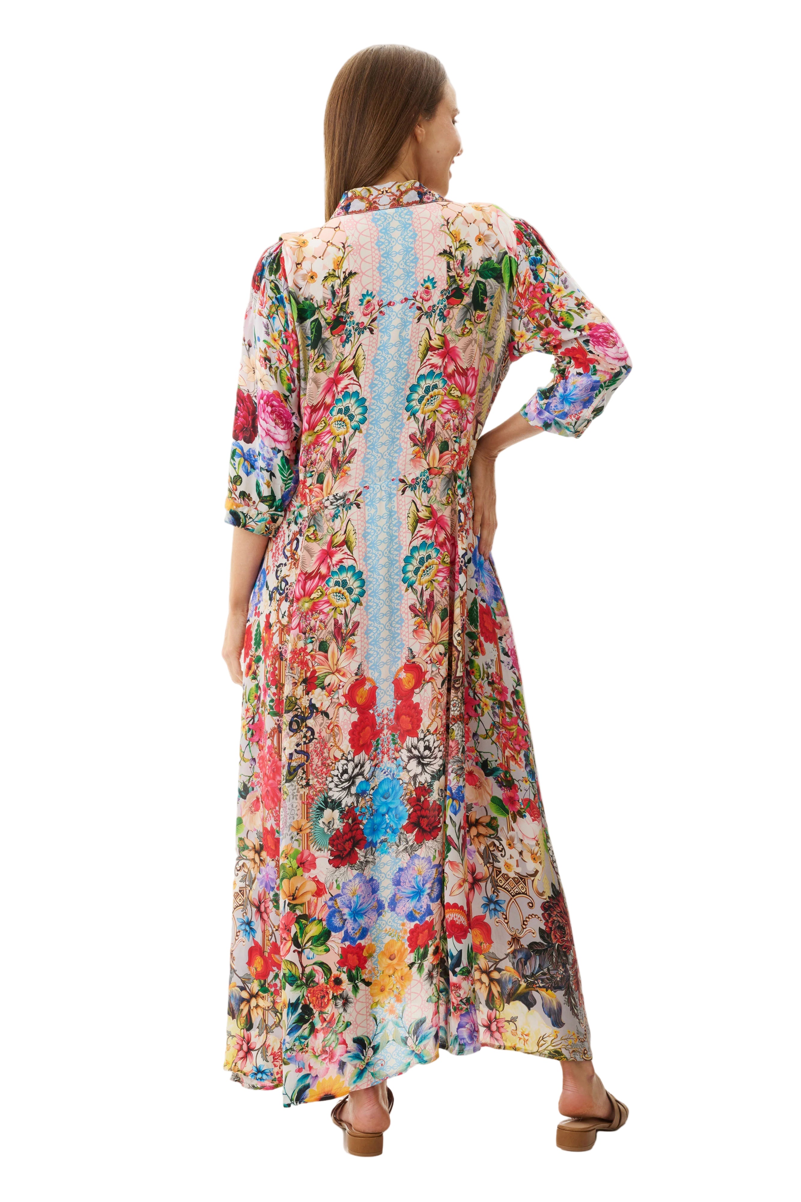 Woman wearing a colorful floral dress on a textured white background