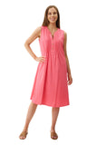 Woman wearing a pink dress on a light beige background