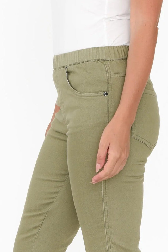 Olive green pants worn by a person on a white background