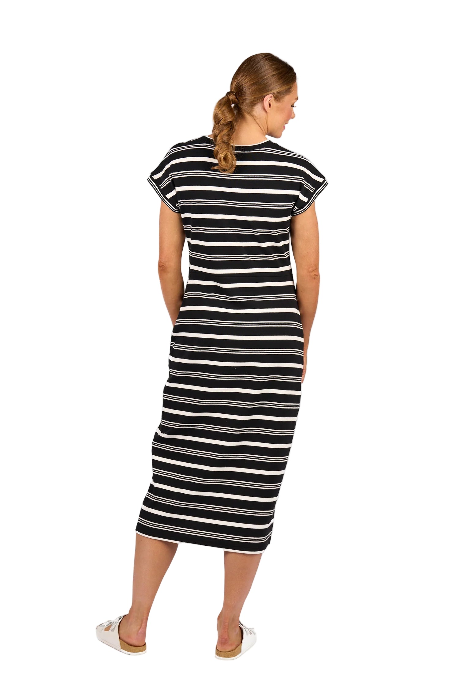 Woman wearing a black and white striped dress on a white background