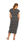 Woman wearing a black and white striped dress on a white background