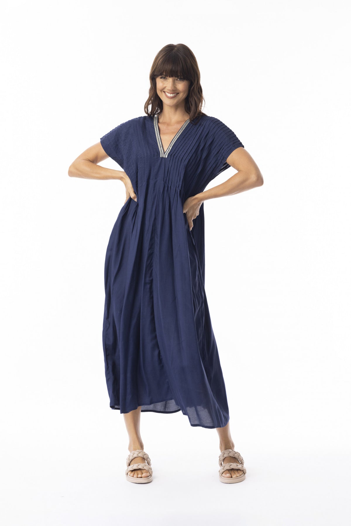 Woman wearing a navy blue dress on a white background