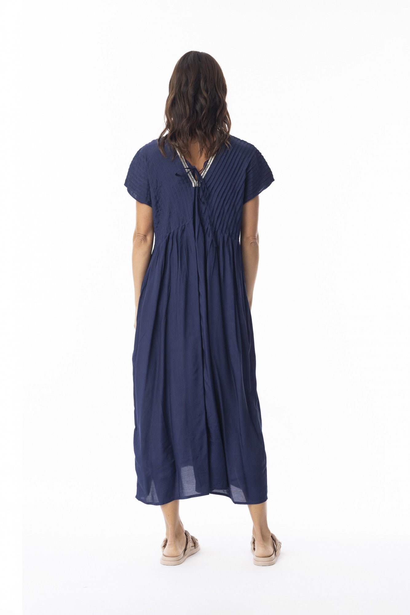 Woman wearing a navy blue dress on a white background