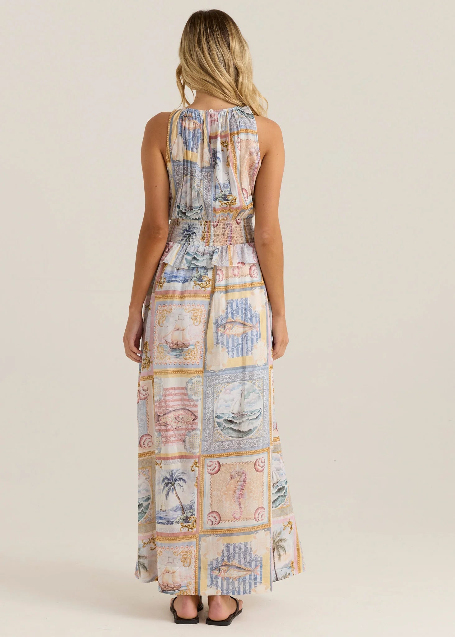 Woman wearing a patterned dress with a neutral background