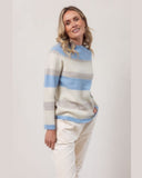 Woman wearing a striped sweater with a plain background