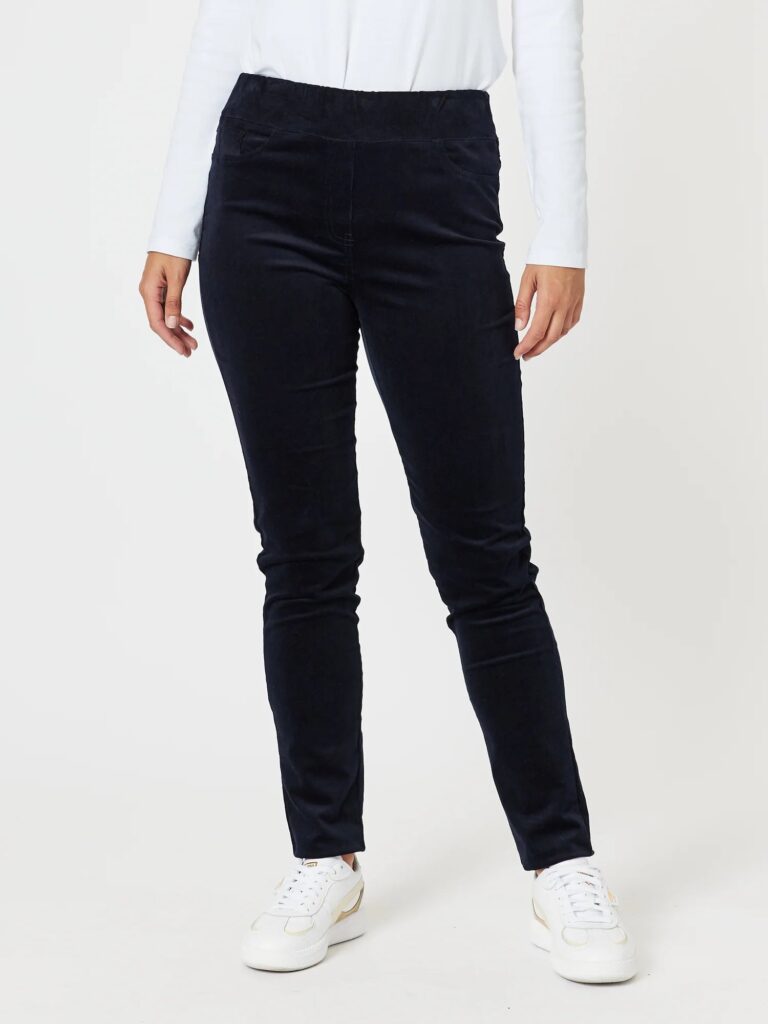 A pair of navy high-waisted, slim leg corduroy pants with a pull-on design, faux front pockets and a crease down the leg.