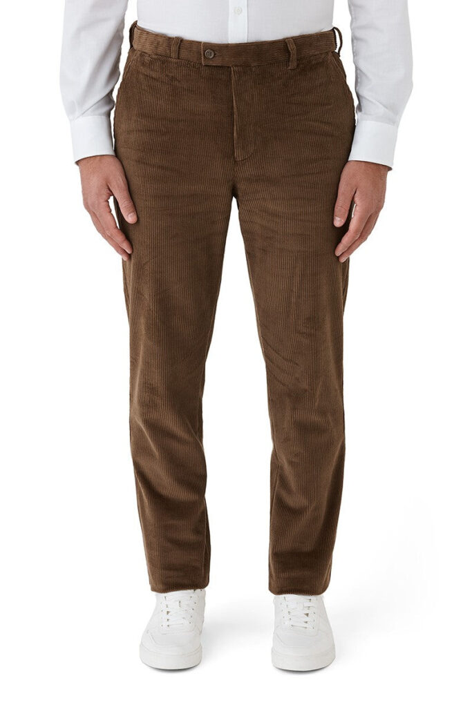 Brown corduroy pants worn by a person on a white background