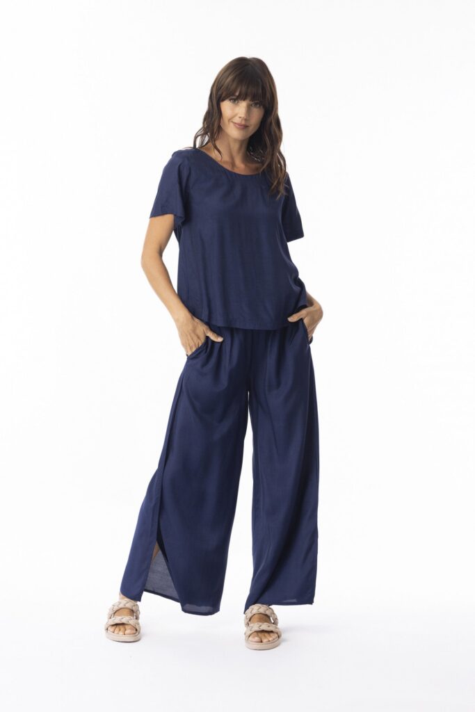 Woman wearing a navy blue outfit on a white background